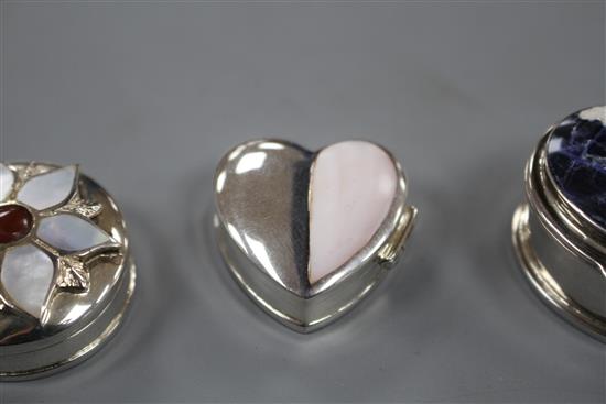 Three assorted modern silver pill boxes, including oval with hardstone lid, heart shaped and circular with shell inset lid, largest 4cm